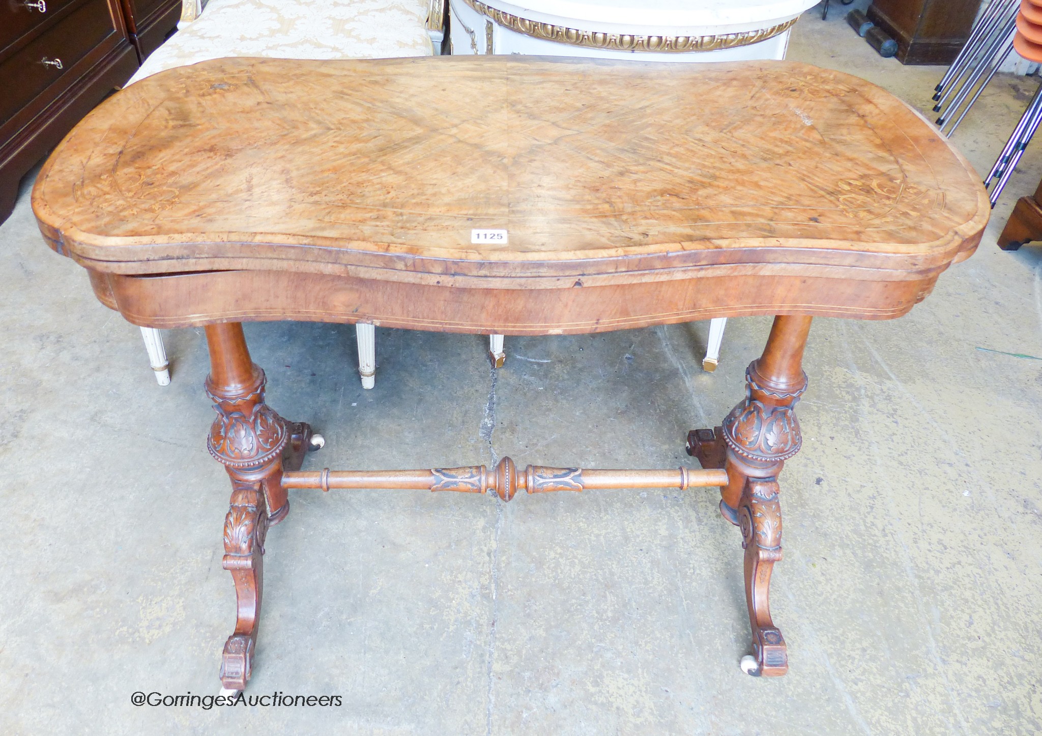 A Victorian inlaid figured walnut serpentine folding top card table, width 97cm, depth 52cm, height 74cm